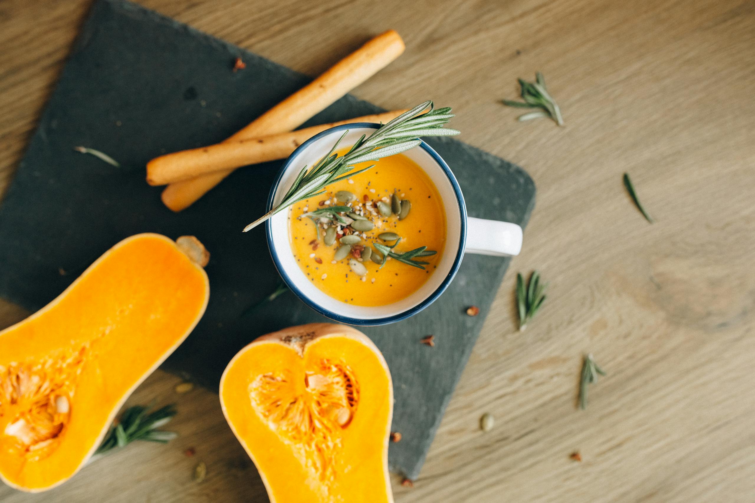 A savory pumpkin soup served with fresh rosemary and seeds, perfect for fall meals.